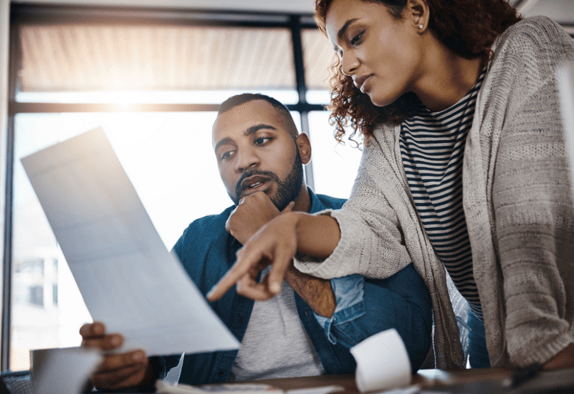 Market researchers reviewing a consent form as part of participant recruitment in qualitative research.