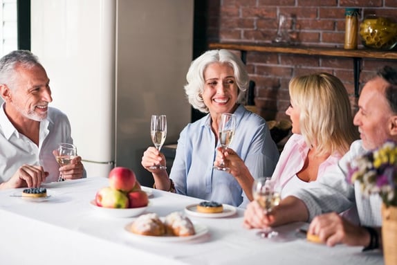 adults enjoying a glass of wine